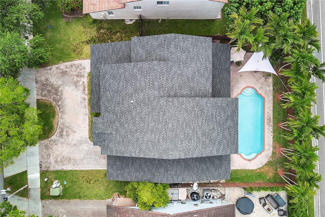 15971 Southwest 96th Terrace Miami, FL 33196 - Photo 4 of 79 an aerial view of a house with a garden and fountain