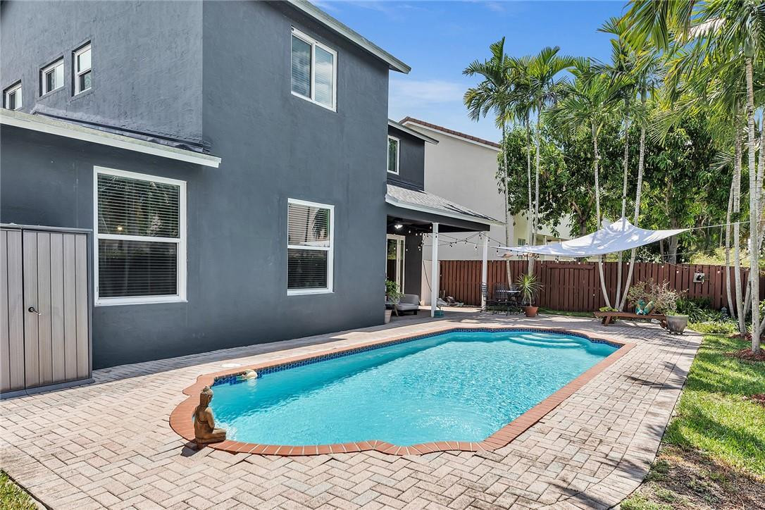 15971 Southwest 96th Terrace Miami, FL 33196 - Photo 49 of 79 a front view of house with yard outdoor seating and barbeque oven