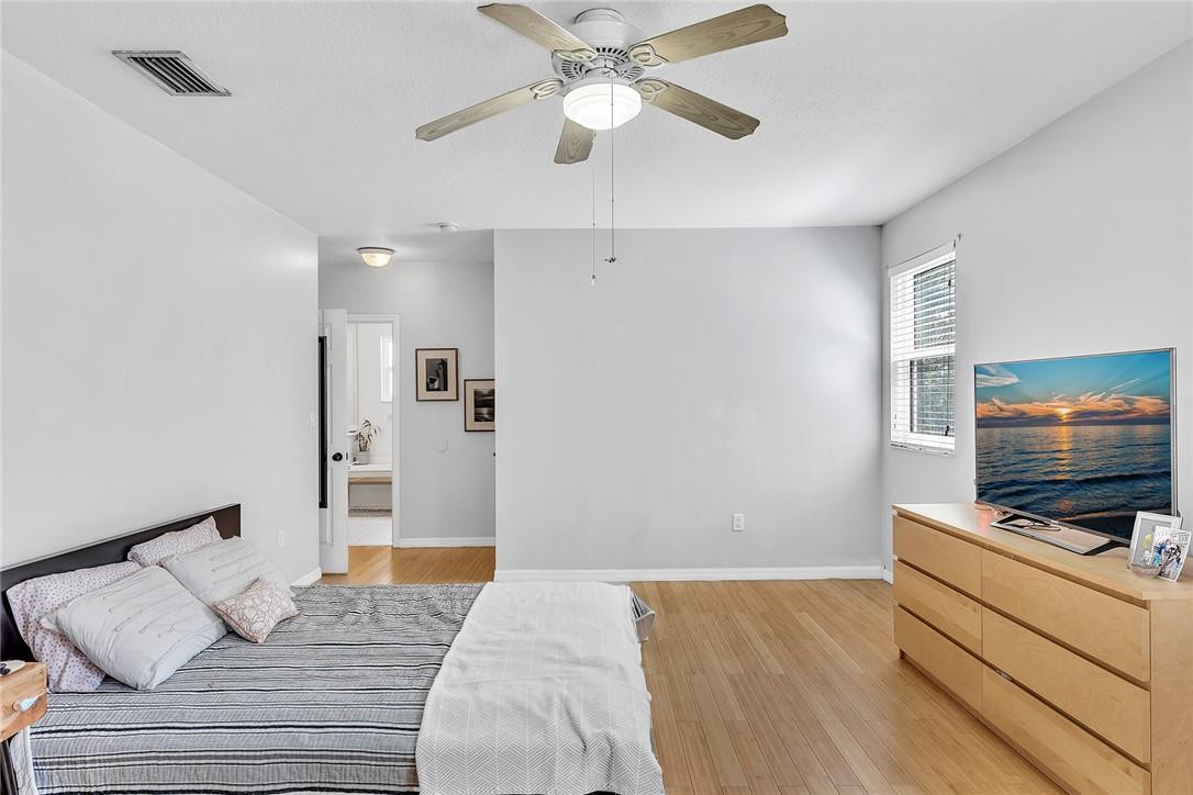 15971 Southwest 96th Terrace Miami, FL 33196 - Photo 56 of 79 a bedroom with a bed and a flat screen tv