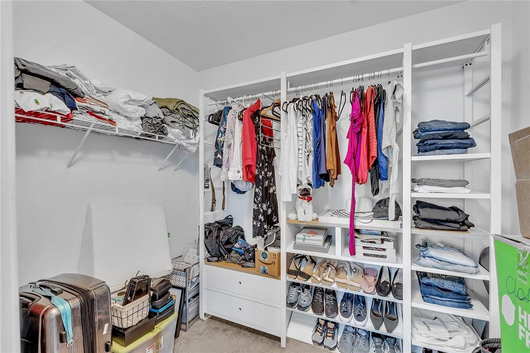 15971 Southwest 96th Terrace Miami, FL 33196 - Photo 57 of 79 a view of walk in closet with clothes and shoes