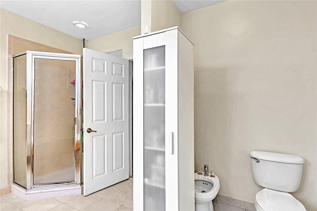 15971 Southwest 96th Terrace Miami, FL 33196 - Photo 61 of 79 a bathroom with a toilet a sink and a mirror