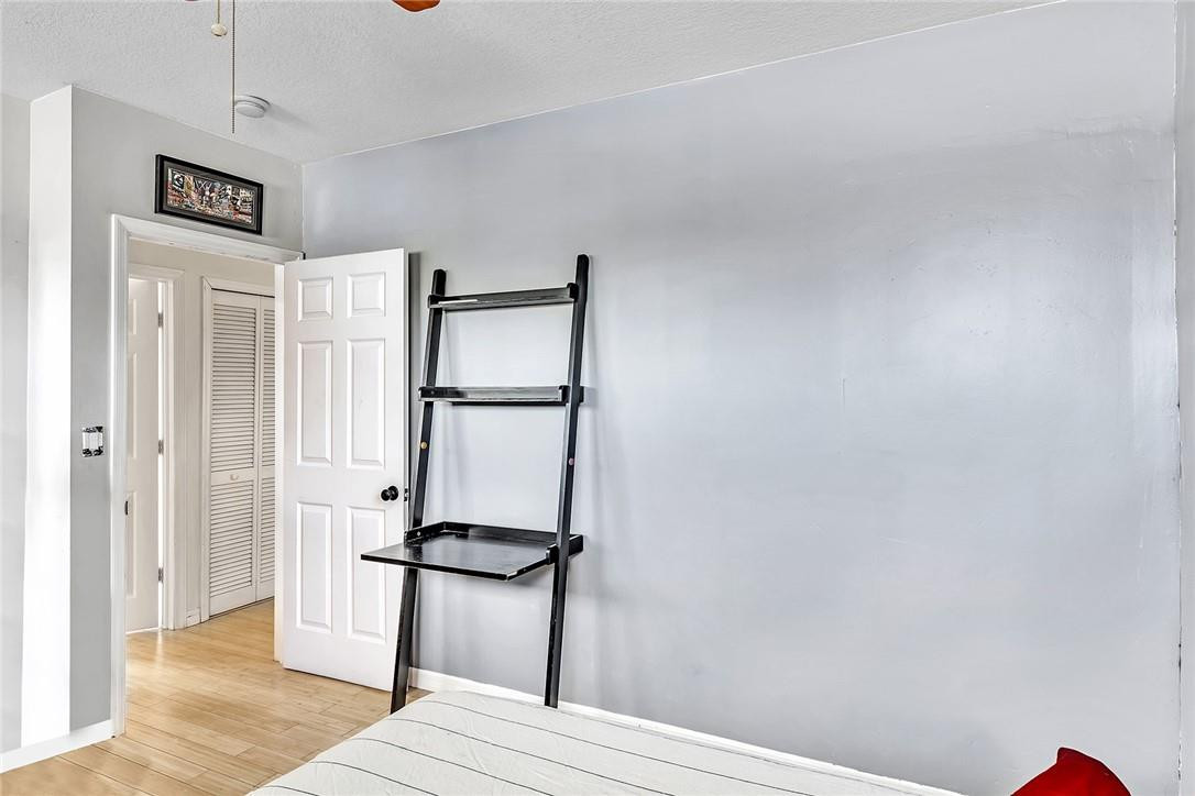 15971 Southwest 96th Terrace Miami, FL 33196 - Photo 68 of 79 a bedroom with a bed and a mirror