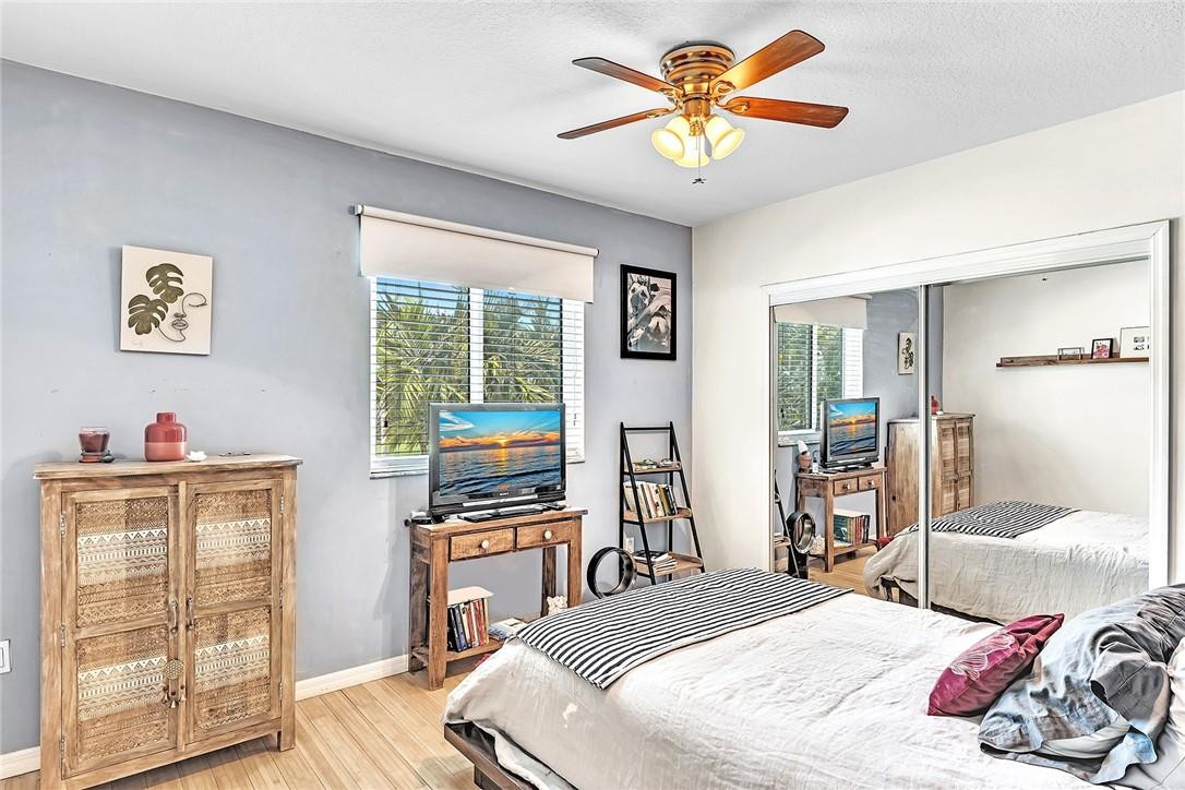 15971 Southwest 96th Terrace Miami, FL 33196 - Photo 69 of 79 a bedroom with a bed and a chandelier