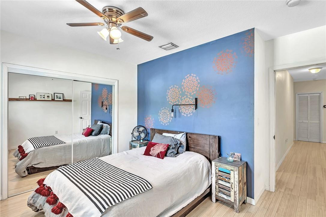 15971 Southwest 96th Terrace Miami, FL 33196 - Photo 70 of 79 a bedroom with two beds and a chandelier