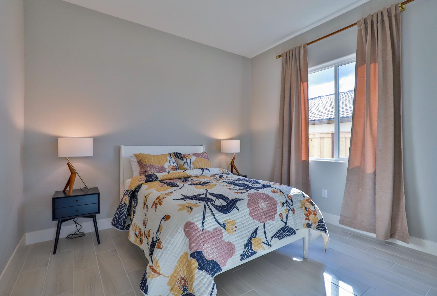 4610 Clb Vista Way Penryn, CA 95663 - Photo 15 of 27 a bedroom with a bed a lamp and a window