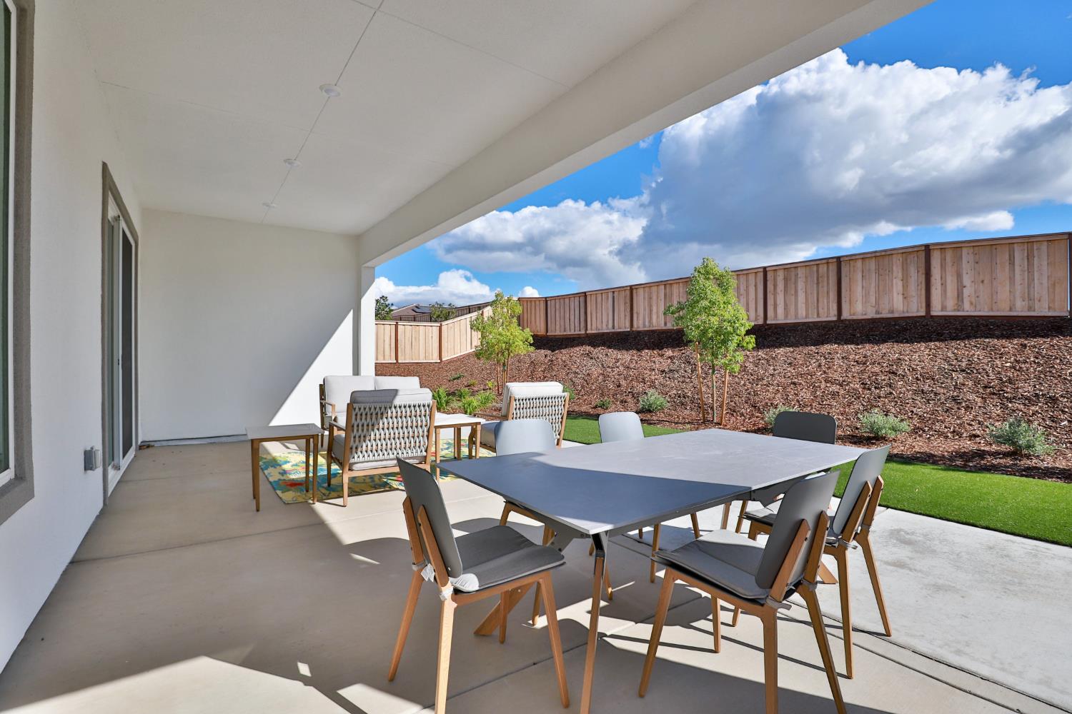 4610 Clb Vista Way Penryn, CA 95663 - Photo 22 of 27 a view of a patio with table and chairs with wooden fence
