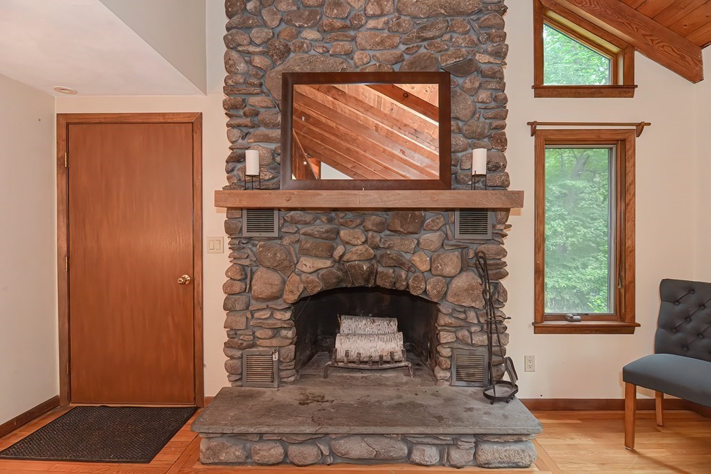 202 Boxboro Road Stow, MA 01775 - Photo 18 of 40 a living room with a fireplace and a window