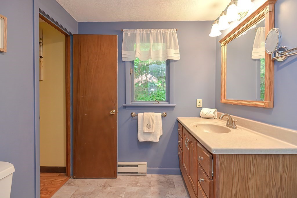 202 Boxboro Road Stow, MA 01775 - Photo 24 of 40 a bathroom with a sink a mirror and a window