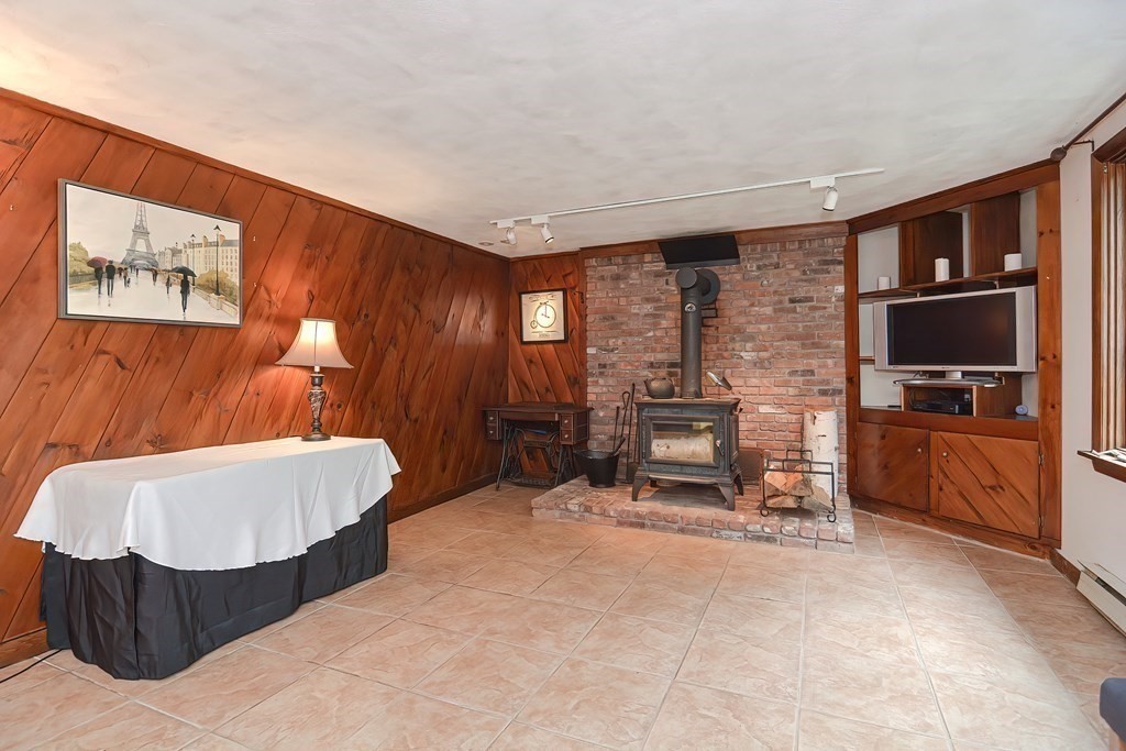 202 Boxboro Road Stow, MA 01775 - Photo 35 of 40 a living room with furniture and a flat screen tv
