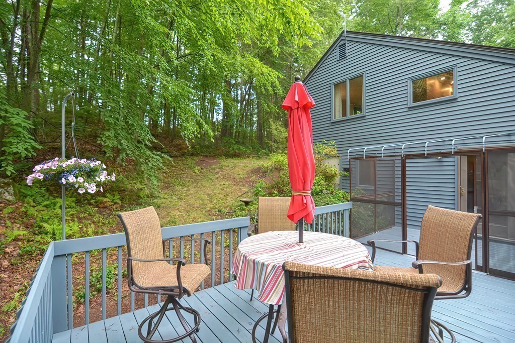 202 Boxboro Road Stow, MA 01775 - Photo 36 of 40 a view of a patio with table and chairs and wooden floor