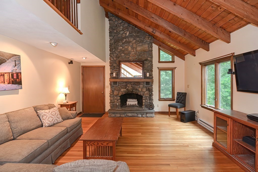 202 Boxboro Road Stow, MA 01775 - Photo 8 of 40 a living room with furniture and a fireplace