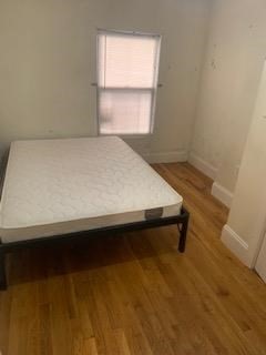 32 Edgerly Road, Unit B Boston, MA 02115 - Photo 3 of 4 a bed sitting in a bedroom next to a window