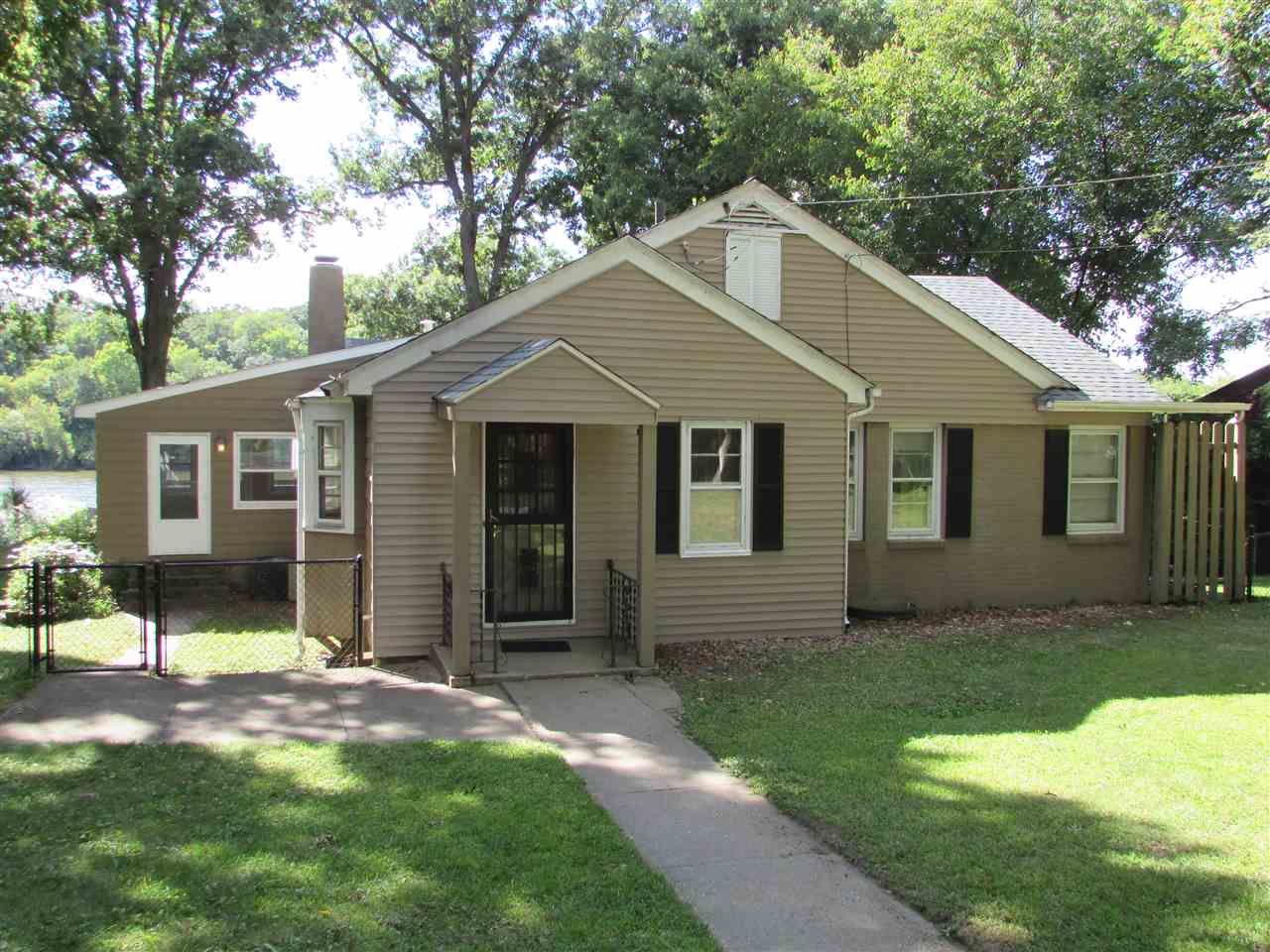 6280 Park Ridge Road Loves Park, IL 61111 - Photo 2 of 25 a front view of a house with a yard and porch