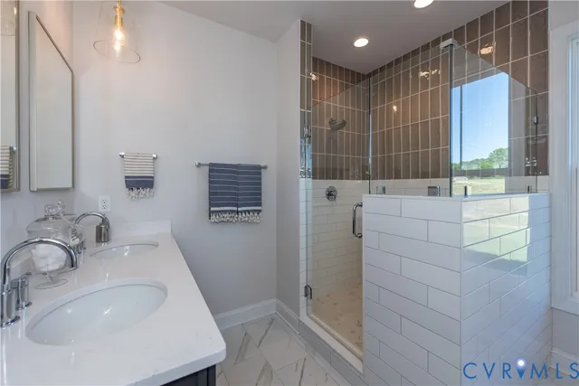 a bathroom with a shower sink and mirror