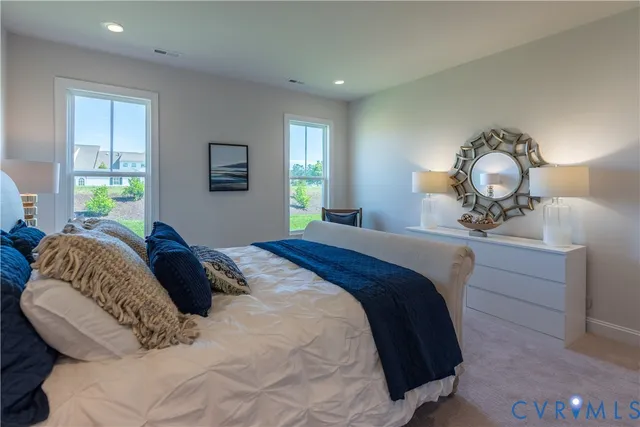 a bedroom with a bed window and a chandelier