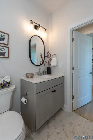 a bathroom with a toilet a sink and a mirror