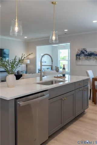 a kitchen with a refrigerator sink and cabinets