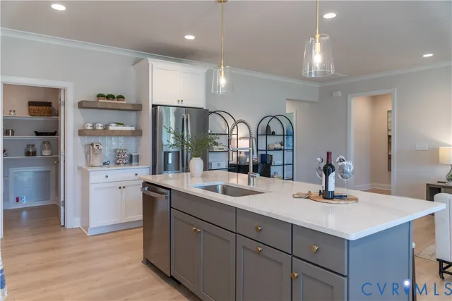 a kitchen with stainless steel appliances granite countertop a stove a sink and a white cabinets