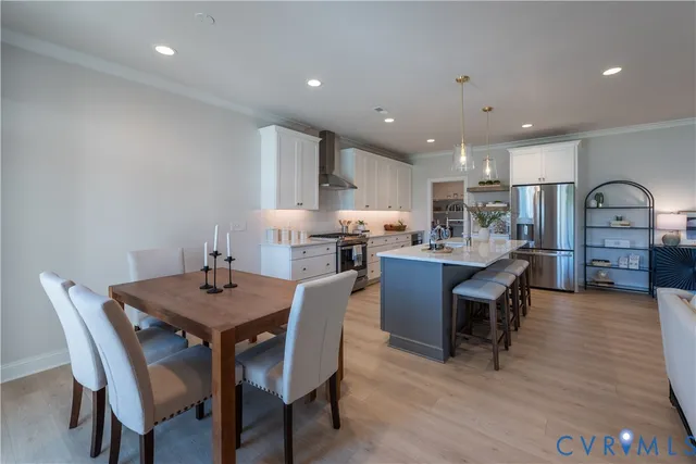 a view of a dining room with furniture and wooden floor