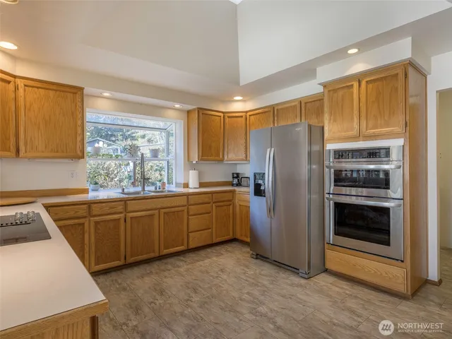 a kitchen with sink a refrigerator and cabinets
