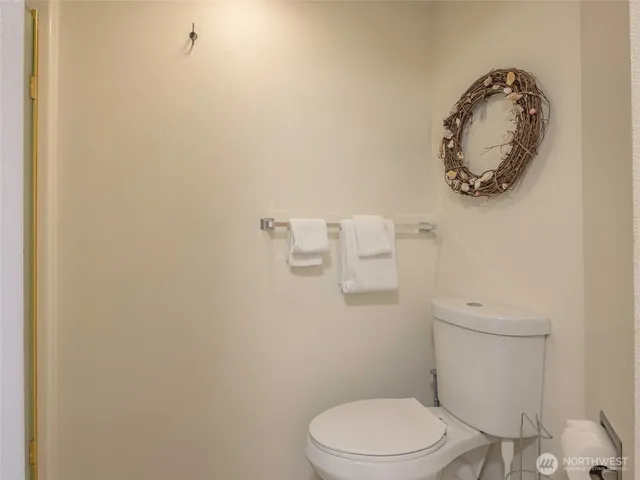 a view of a hallway with wooden floor and entryway