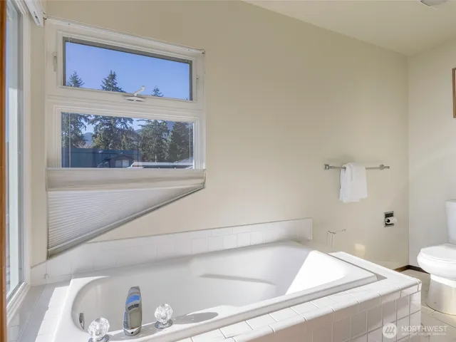 a spacious bathroom with a double vanity sink and a mirror