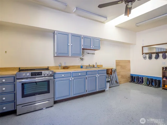 a living room with lots of furniture and a kitchen view
