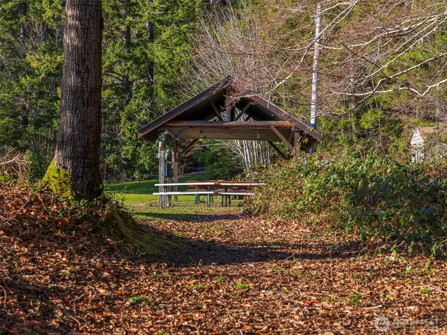 a view of a house with pool and yard