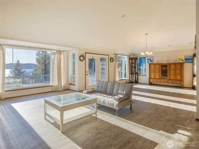 a living room with furniture and a floor to ceiling window