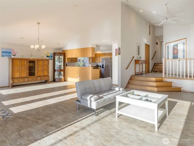 a kitchen with granite countertop a refrigerator stove top oven and sink