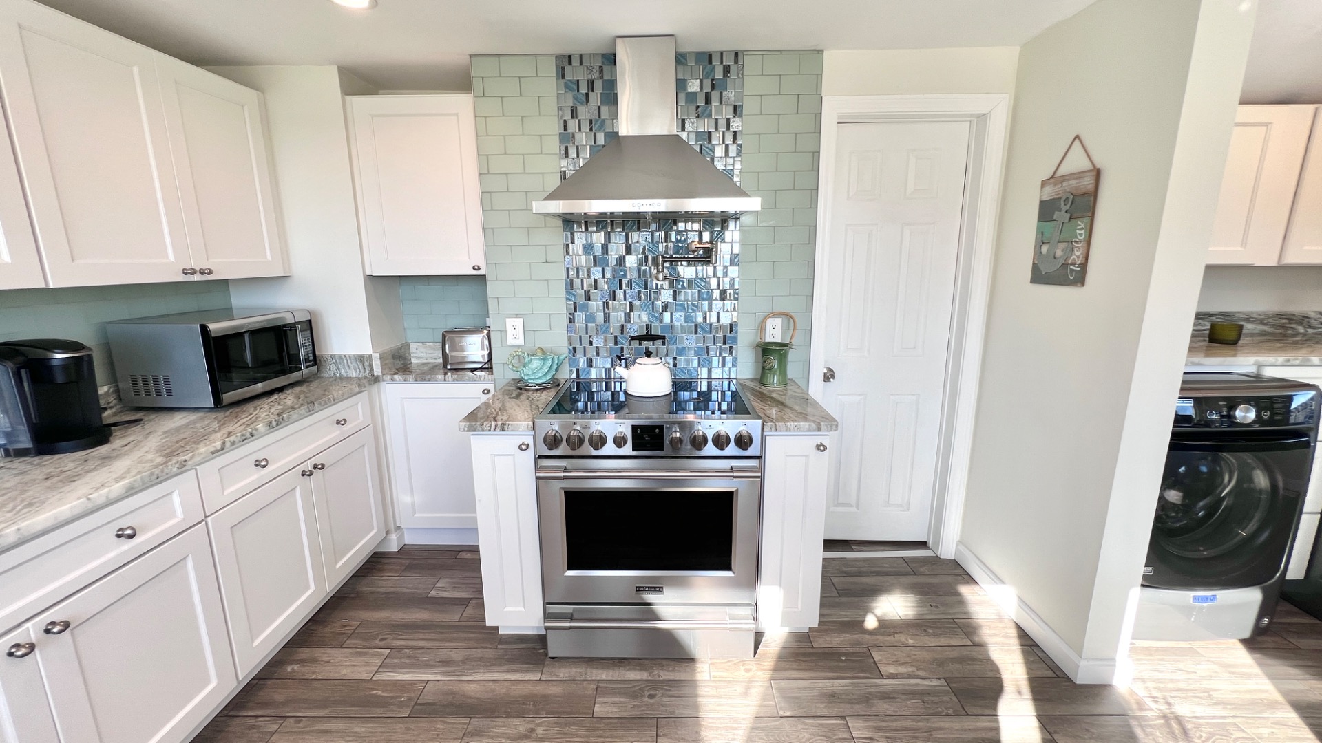 34 Windemere Road Oak Bluffs, MA 02557 - Photo 11 of 64 a kitchen with stainless steel appliances granite countertop a stove and a white cabinets