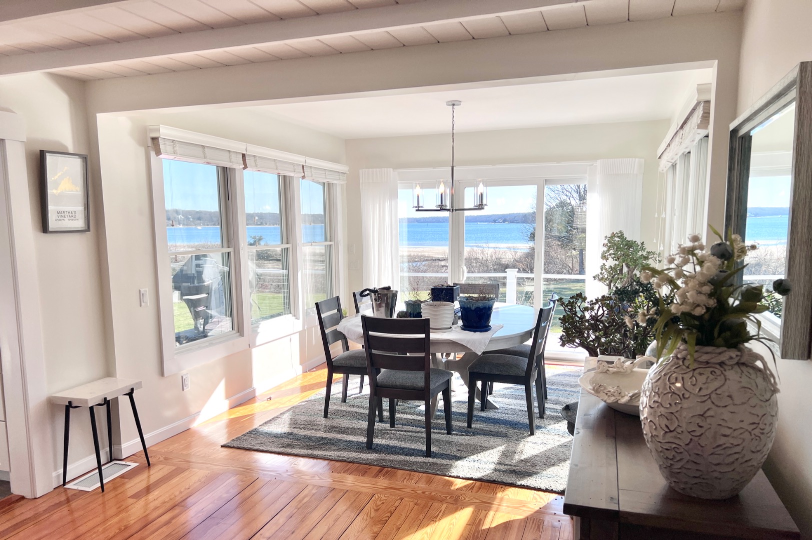 34 Windemere Road Oak Bluffs, MA 02557 - Photo 19 of 64 a dining room with furniture a chandelier and wooden floor