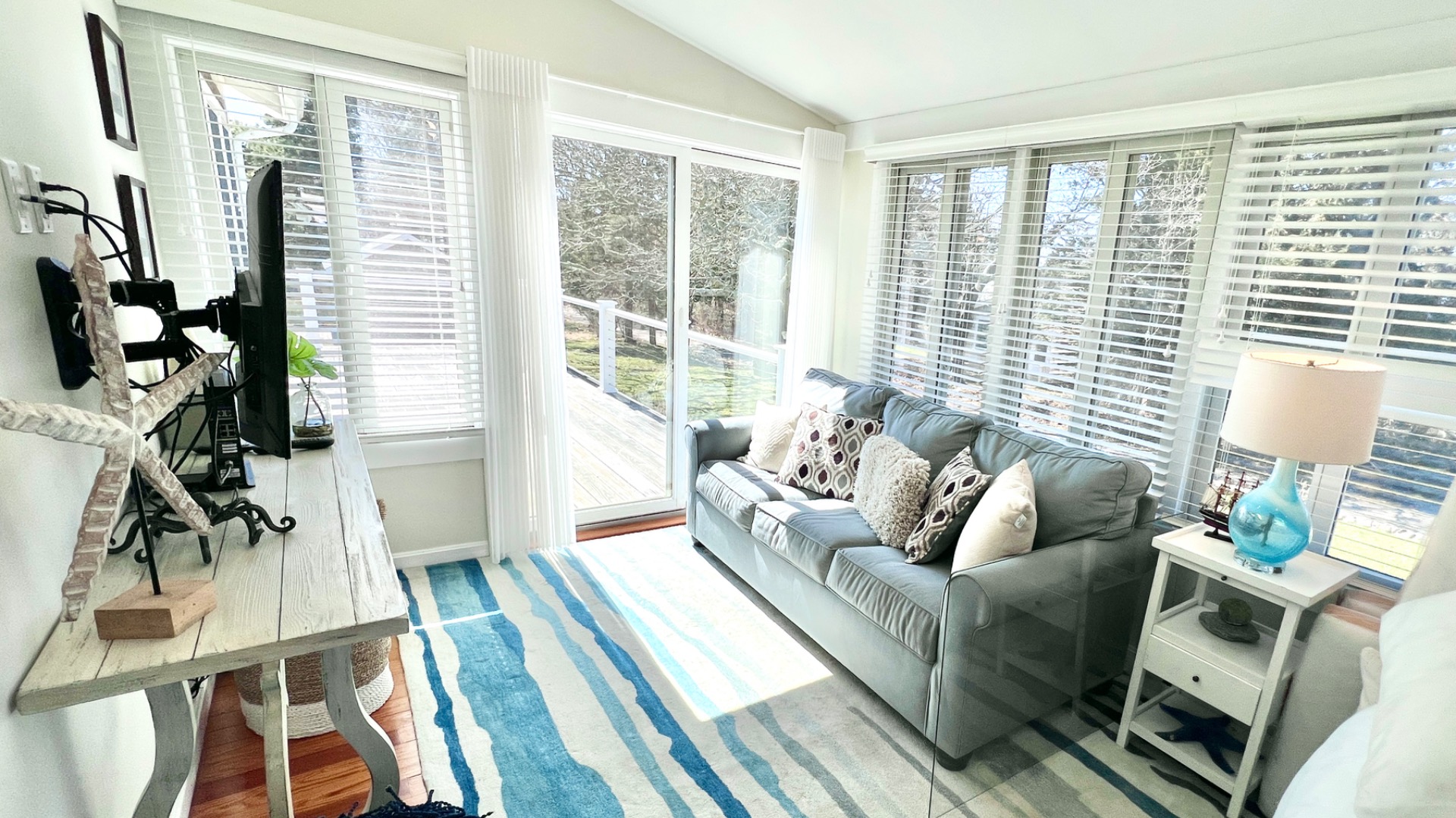 34 Windemere Road Oak Bluffs, MA 02557 - Photo 23 of 64 a living room with furniture and floor to ceiling windows