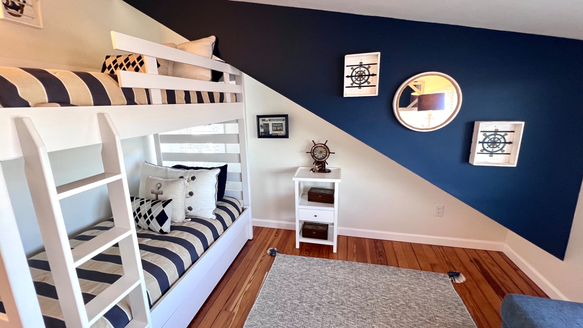 34 Windemere Road Oak Bluffs, MA 02557 - Photo 47 of 64 a living room with a bed and a painting on the wall