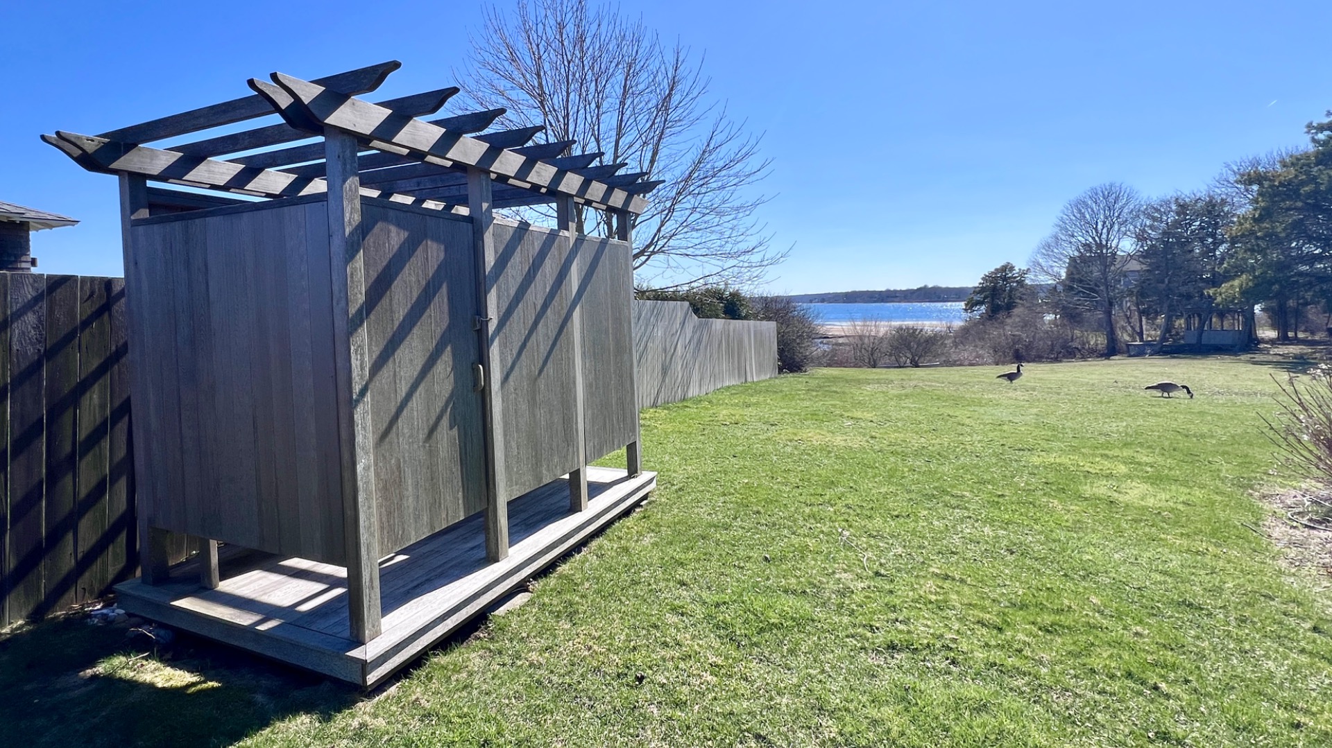 34 Windemere Road Oak Bluffs, MA 02557 - Photo 54 of 64 a view of a backyard with lawn chairs and a fireplace