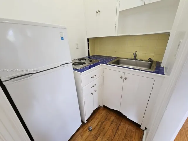 a utility room with cabinets washer and dryer