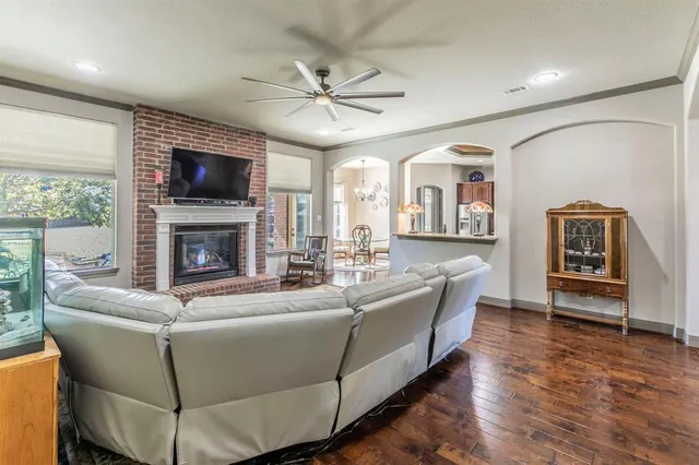 a living room with furniture a flat screen tv and a fireplace