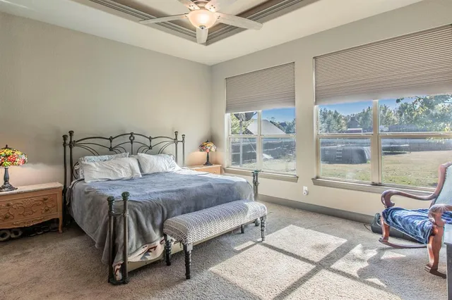 a bedroom with a bed a table and chair