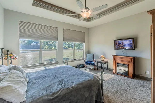 a spacious bedroom with a bed and a fireplace