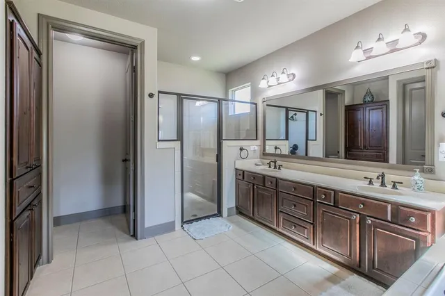 a bathroom with a sink a mirror and a shower