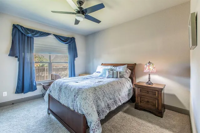 a bedroom with a bed and ceiling fan