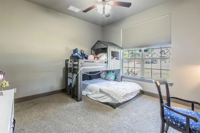 a bedroom with a bed a desk and chair