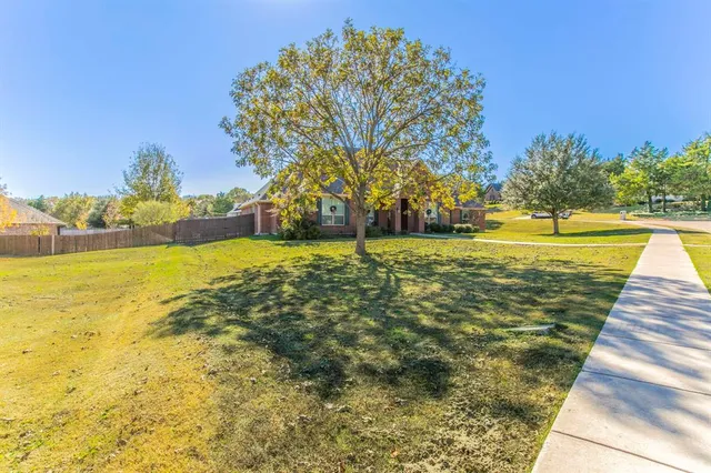 a view of house with outdoor space and sitting area