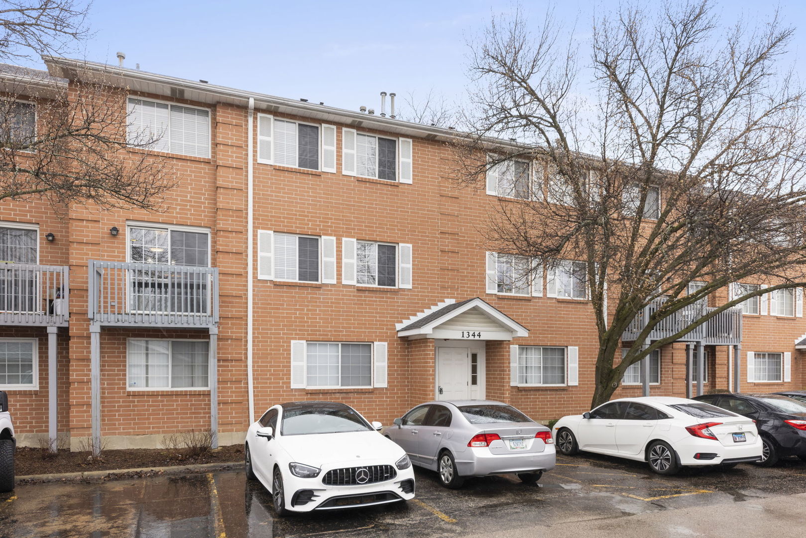 1344 South Lorraine Road, Unit E Wheaton, IL 60189 - Photo 1 of 26 a car parked in front of a brick house