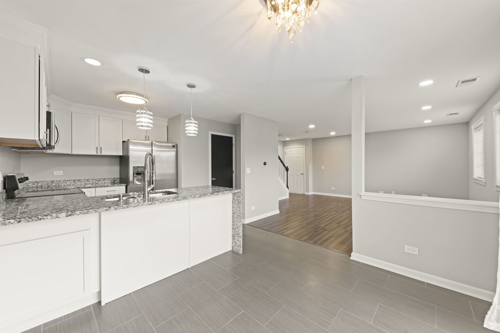 1344 South Lorraine Road, Unit E Wheaton, IL 60189 - Photo 3 of 26 a large kitchen with a sink stainless steel appliances and cabinets