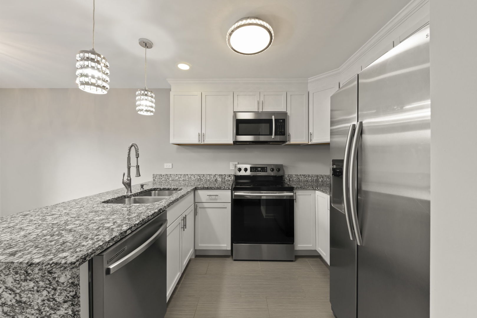 1344 South Lorraine Road, Unit E Wheaton, IL 60189 - Photo 6 of 26 a kitchen with stainless steel appliances granite countertop a refrigerator a stove a sink and a microwave