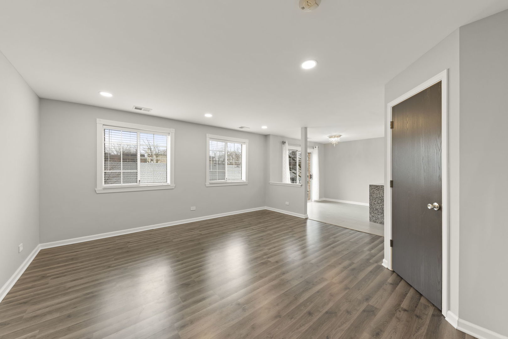 1344 South Lorraine Road, Unit E Wheaton, IL 60189 - Photo 8 of 26 a view of an empty room with wooden floor and a window
