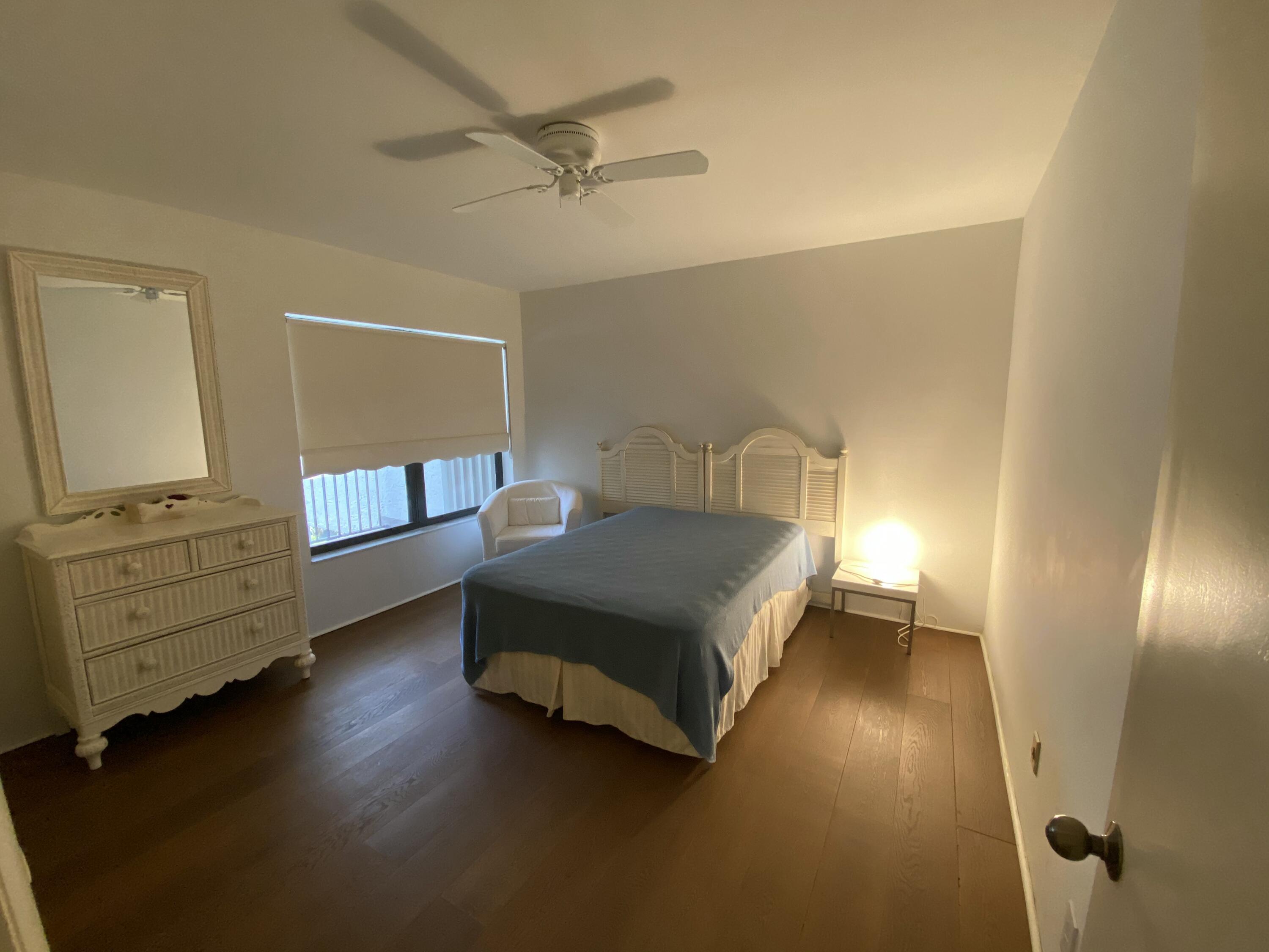 5801 North Ocean Boulevard, Unit 208 Ocean Ridge, FL 33435 - Photo 7 of 7 a bedroom with a bed and furniture