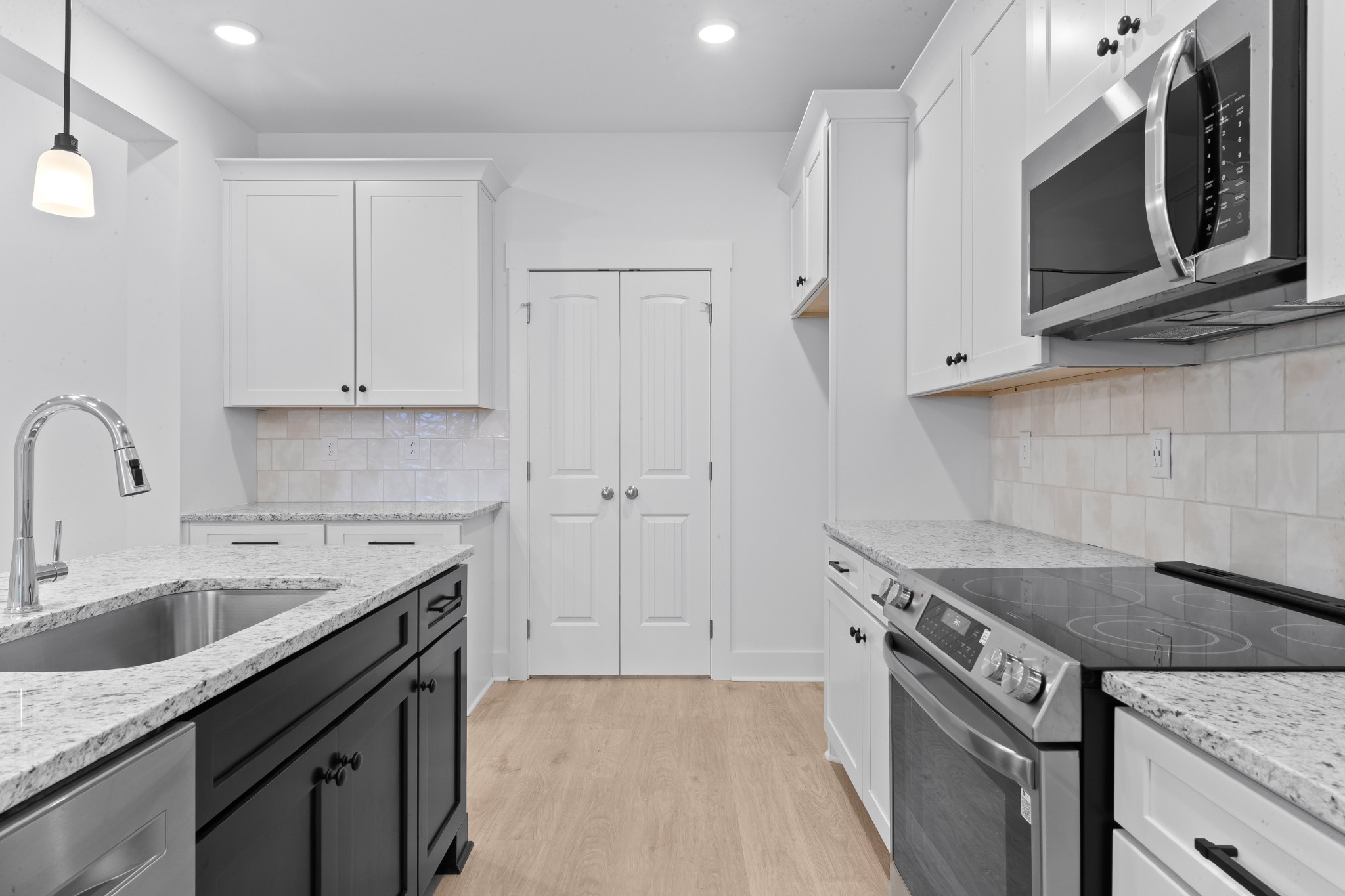 232 Dugout Road Summertown, TN 38483 - Photo 39 of 64 a kitchen with granite countertop a sink a stove and cabinets