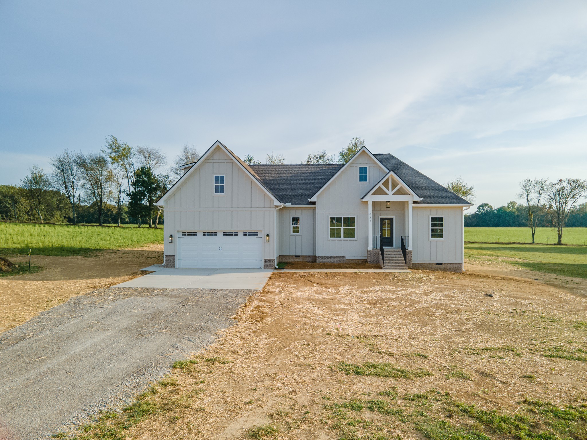 232 Dugout Road Summertown, TN 38483 - Photo 6 of 64 a front view of a house with a yard and garage